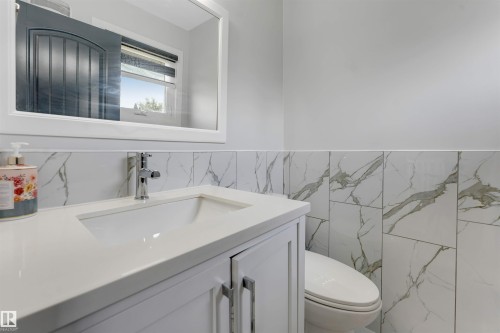 Bathroom vanity with an integrated sink and chrome faucet - 7419 33 Avenue Nw, Edmonton, AB - Indoor Photo Showing Bathroom