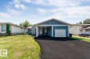Ranch-style residence featuring a blue exterior finish and white trim - 7419 33 Avenue Nw, Edmonton, AB  - Outdoor With Facade 