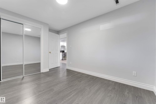 Bedroom featuring wood-finish flooring and light gray painted walls - 7419 33 Avenue Nw, Edmonton, AB - Indoor Photo Showing Other Room