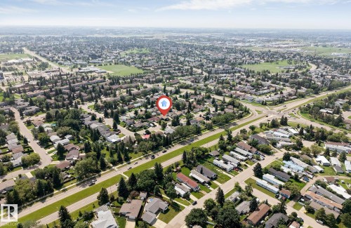 Expansive aerial view showcasing a residential neighborhood with detached homes, mature trees, and arterial roads - 7419 33 Avenue Nw, Edmonton, AB - Outdoor With View
