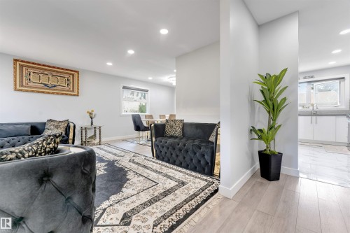 Open concept living area with recessed lighting, light wood-finish flooring, and light gray wall paint - 7419 33 Avenue Nw, Edmonton, AB - Indoor Photo Showing Living Room