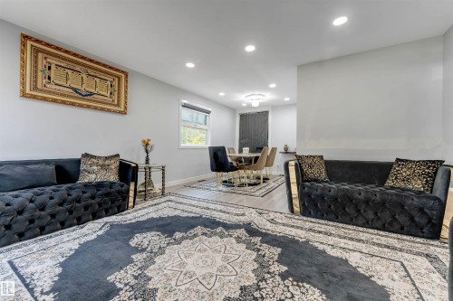 Open concept living and dining area featuring recessed lighting, a window with horizontal blinds, and wood-finish flooring - 7419 33 Avenue Nw, Edmonton, AB - Indoor Photo Showing Living Room