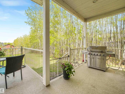 Covered outdoor patio with a textured concrete surface - 16 Crystal Keys Crescent, Rural Wetaskiwin County, AB - Outdoor With Deck Patio Veranda With Exterior