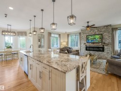 Kitchen island with light-toned granite countertop and built-in sink - 