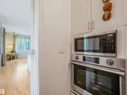 Built-in stainless steel microwave and oven combination with white cabinetry - 