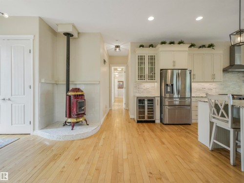 Open-concept living area with light wood-finish flooring - 16 Crystal Keys Crescent, Rural Wetaskiwin County, AB - Indoor Photo Showing Kitchen With Upgraded Kitchen