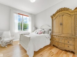 Bright room featuring a large window with exterior scenery, light wood-finish flooring, and light-toned wall paint - 
