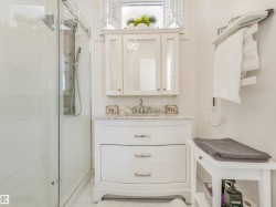 White shaker-style vanity with curved drawer fronts, marble-finish countertop, and undermount sink - 