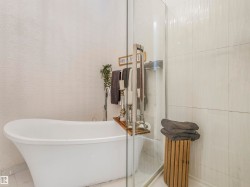 Freestanding soaking tub with floor-mounted faucet - 