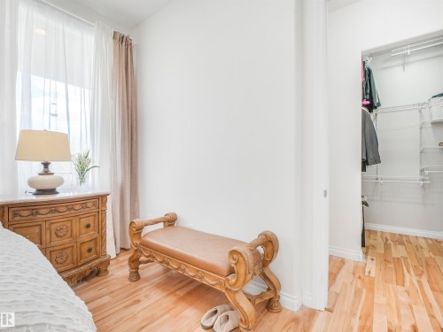 Light wood-finish flooring extending from the room into a closet with wire shelving - 16 Crystal Keys Crescent, Rural Wetaskiwin County, AB - Indoor