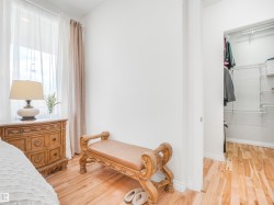 Light wood-finish flooring extending from the room into a closet with wire shelving - 