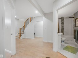 Open concept space featuring light wood-finish flooring - 