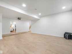 Spacious room featuring light wood-finish flooring, recessed lighting, and a neutral color palette - 