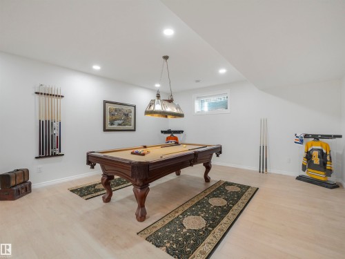 Recreation room featuring a pool table with an overhead light fixture, light wood-finish flooring, recessed ceiling lights, and a window with blinds - 16 Crystal Keys Crescent, Rural Wetaskiwin County, AB - Indoor Photo Showing Other Room