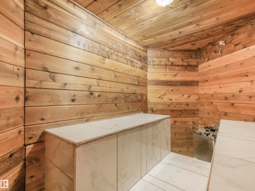 Wood-paneled interior featuring horizontal plank walls and a sloped ceiling - 16 Crystal Keys Crescent, Rural Wetaskiwin County, AB - Indoor Photo Showing Other Room
