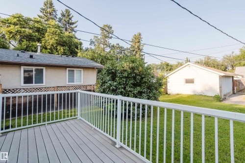 Expansive outdoor deck featuring grey composite decking and white railings - 12431 81 Street Nw, Edmonton, AB - Outdoor With Exterior