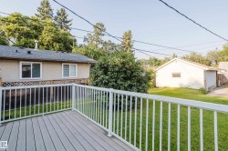 Expansive outdoor deck featuring grey composite decking and white railings - 