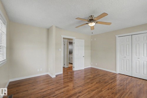 Spacious interior room featuring wood-finish flooring, neutral wall tones, and a ceiling fan with integrated lighting - 8823 130A Avenue Nw, Edmonton, AB - Indoor Photo Showing Other Room