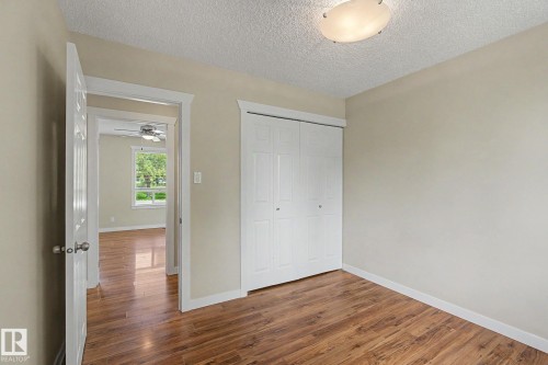 Room featuring wood-finish flooring, neutral wall paint, and white trim - 8823 130A Avenue Nw, Edmonton, AB - Indoor Photo Showing Other Room