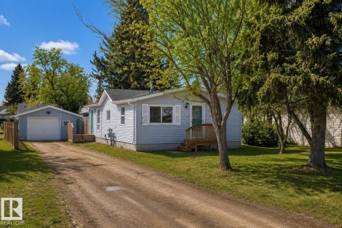 Light blue siding exterior featuring white trim and shutters - 4712 49 Street, Calmar, AB - Outdoor