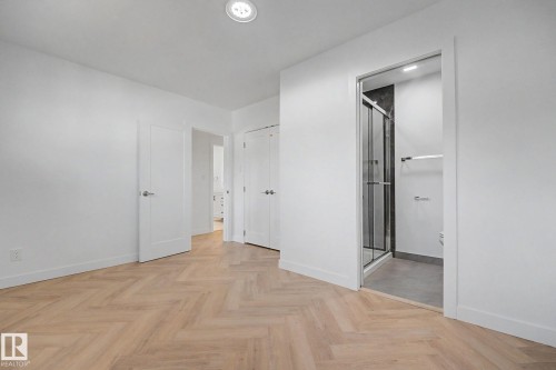 Bedroom featuring herringbone wood-finish flooring, recessed lighting, and white baseboards - 10570 66 Avenue Nw, Edmonton, AB - Indoor Photo Showing Other Room