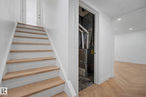 Staircase with light wood treads and white risers - 10570 66 Avenue Nw, Edmonton, AB - Indoor Photo Showing Other Room