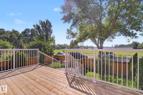Spacious wood-finish deck with white railings and stairs - 10570 66 Avenue Nw, Edmonton, AB - Outdoor With Deck Patio Veranda