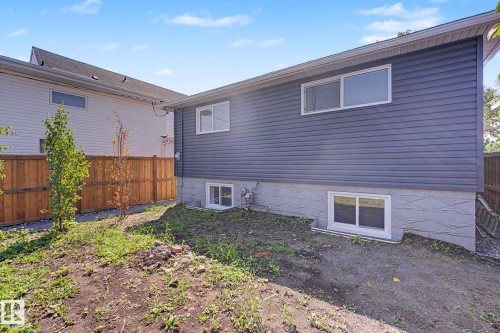 Exterior siding in a deep blue hue, complemented by a light gray foundation - 10570 66 Avenue Nw, Edmonton, AB - Outdoor With Exterior