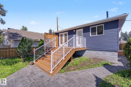 Exterior featuring blue horizontal siding and white trim - 10570 66 Avenue Nw, Edmonton, AB - Outdoor With Deck Patio Veranda With Exterior