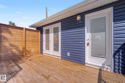 Wood-finish deck with a privacy screen - 10570 66 Avenue Nw, Edmonton, AB - Outdoor With Exterior