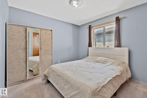 Bedroom featuring light blue walls and a textured ceiling - 2819 33 Street Nw, Edmonton, AB - Indoor Photo Showing Bedroom