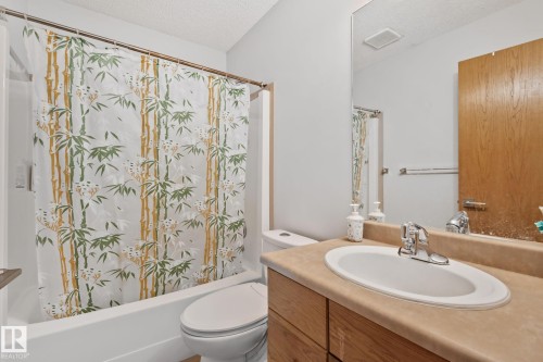 Bathroom featuring a built-in vanity with a light wood-finish cabinet and a light beige countertop - 2819 33 Street Nw, Edmonton, AB - Indoor Photo Showing Bathroom
