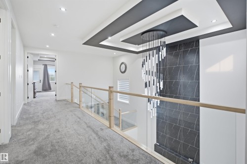 Upper-level hallway with gray carpet flooring and recessed lighting - 304 33 Avenue Nw, Edmonton, AB - Indoor Photo Showing Other Room