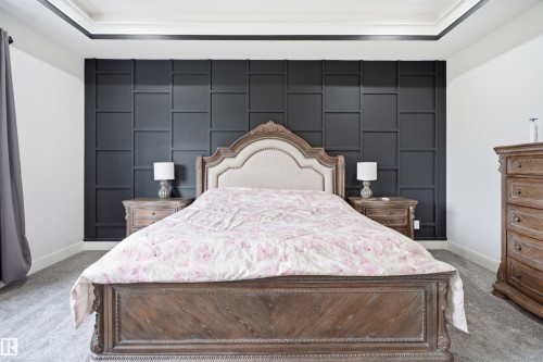 Accent wall with dark paneling and a tray ceiling with dark trim - 304 33 Avenue Nw, Edmonton, AB - Indoor Photo Showing Bedroom
