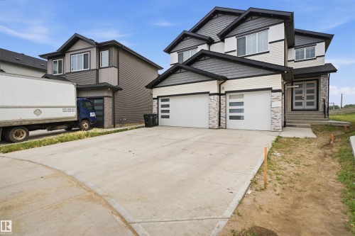 Contemporary multi-level residence featuring a double-wide concrete driveway - 304 33 Avenue Nw, Edmonton, AB - Outdoor