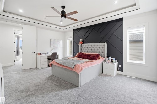 Spacious room with tray ceiling, recessed lighting, and a modern ceiling fan - 304 33 Avenue Nw, Edmonton, AB - Indoor Photo Showing Bedroom