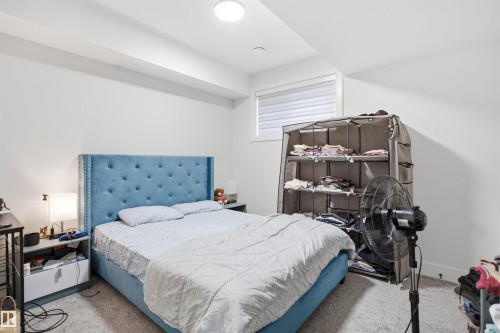 Carpeted bedroom featuring white walls, a recessed ceiling light, and a window with blinds - 304 33 Avenue Nw, Edmonton, AB - Indoor Photo Showing Bedroom