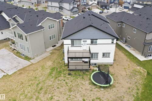 Contemporary two-story exterior with white siding and dark trim, featuring a multi-level deck with black railings - 304 33 Avenue Nw, Edmonton, AB - Outdoor