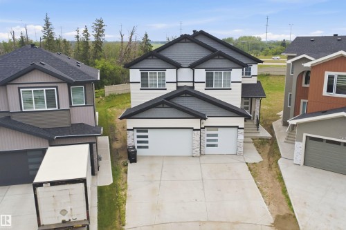 Contemporary two-story residence featuring a two-car garage with modern frosted glass inserts - 304 33 Avenue Nw, Edmonton, AB - Outdoor With Facade