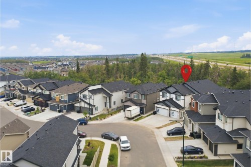 Modern residential community featuring varied architectural styles and dark shingle roofs - 304 33 Avenue Nw, Edmonton, AB - Outdoor With View