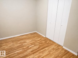 Neutral-toned walls complementing wood-finish flooring - 