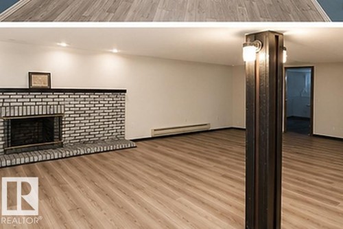Spacious room with wood-finish flooring, a brick fireplace with a black mantel, recessed lighting, and wall-mounted sconces on a structural column - 7812 144 Avenue Nw, Edmonton, AB - Indoor With Fireplace