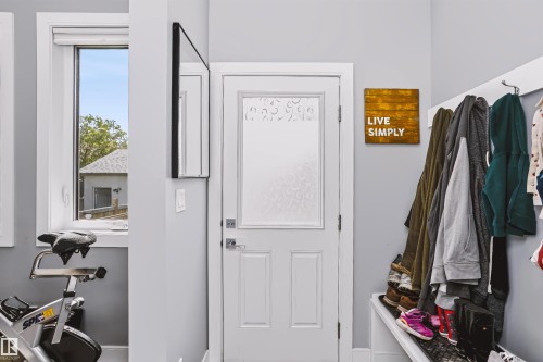 Entryway featuring a white paneled door with frosted glass, light gray walls, and a multi-pane window - 11305 79 Avenue Nw, Edmonton, AB - Indoor