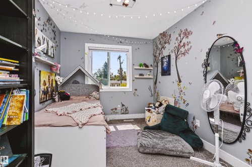 Carpeted room featuring a white-trimmed window, built-in shelving, and light gray walls - 11305 79 Avenue Nw, Edmonton, AB - Indoor