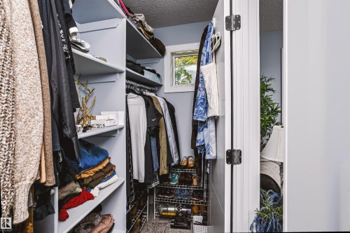 Built-in closet system with multiple shelving units and hanging rods - 11305 79 Avenue Nw, Edmonton, AB - Indoor With Storage