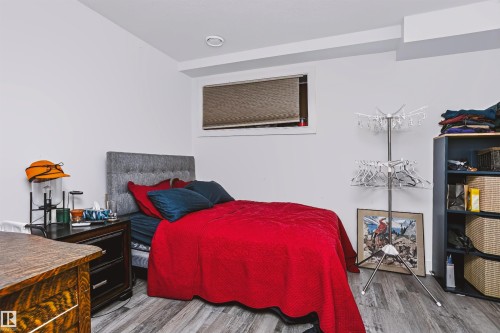 Bedroom with neutral wall tones and wood-finish flooring - 11305 79 Avenue Nw, Edmonton, AB - Indoor Photo Showing Bedroom