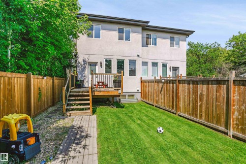 Private backyard with a deck and wood fencing - 11305 79 Avenue Nw, Edmonton, AB - Outdoor With Deck Patio Veranda