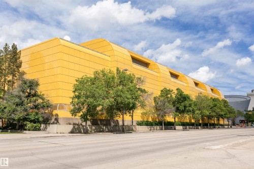 Contemporary architectural design featuring a bold yellow facade, curved rooflines, and horizontal paneling - 11305 79 Avenue Nw, Edmonton, AB - Outdoor
