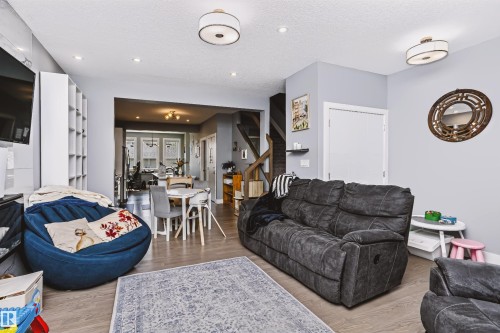 Bright living space featuring wood-finish flooring and recessed lighting - 11305 79 Avenue Nw, Edmonton, AB - Indoor Photo Showing Living Room