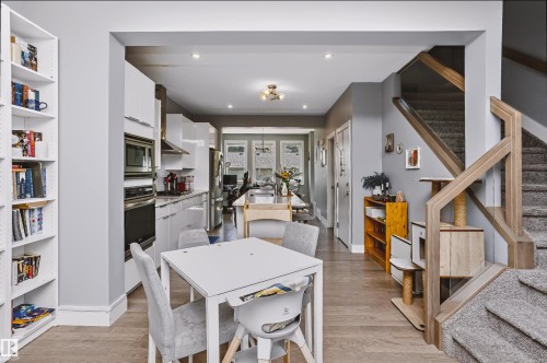 Open-concept interior featuring light wood-finish flooring and grey wall tones - 11305 79 Avenue Nw, Edmonton, AB - Indoor